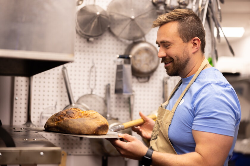 Co-Owner and Chef Noah Zamler takes a loaf of bread out of the oven at Irene's Finer Diner in North Center on the North Side, Thursday, May 14, 2026.