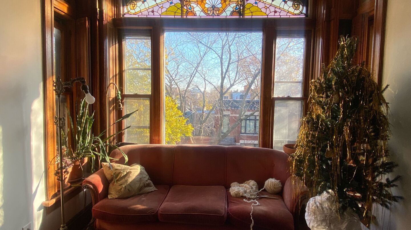 Sophie and Isabelle Lynch’s living room features stained-glass windows and vintage furniture they’ve collected over the years.