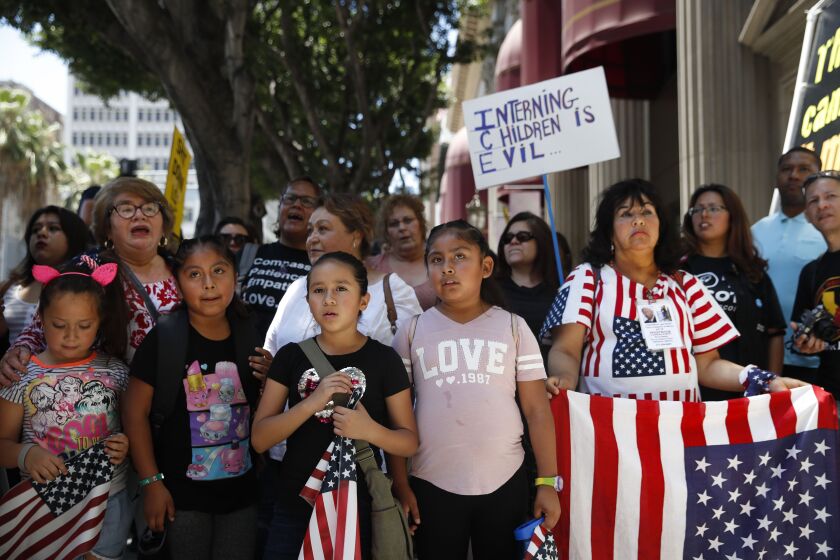 People gather outside the Millennium Biltmore Hotel to protest against U.S. Attorney General Jeff Sessions, Tuesday, June 26, 2018, in Los Angeles. Sessions gave a speech at the hotel. (AP Photo/Jae C. Hong)