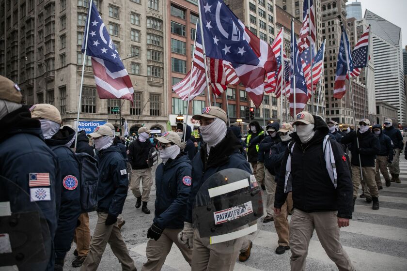 Patriot Front, a group that the Southern Poverty Law Center classified as a white nationalist hate group that broke off from Vanguard America after the “Unite the Right” rally in Charlottesville, Virginia in 2017, march down South Michigan Avenue in the Loop as anti-abortion activists march across the street during a March for Life rally, Saturday afternoon, Jan. 8, 2022.