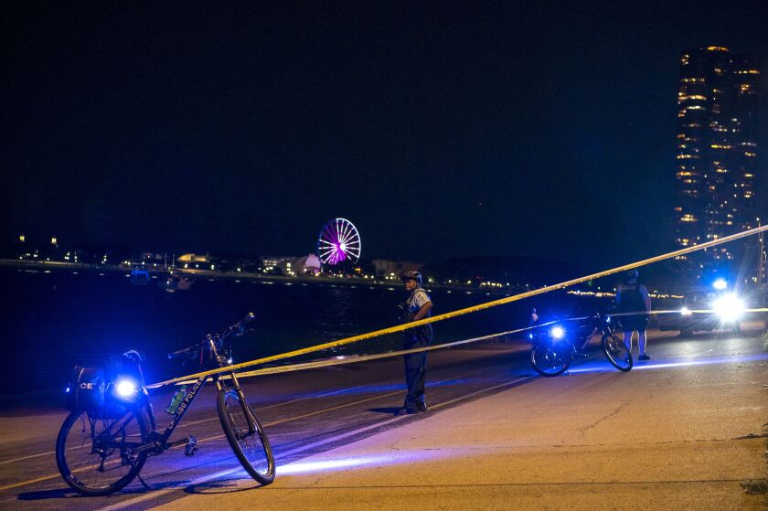 Crime scene tape blocks off a portion of the Lakefront Trail near the 800 block of North Lake Shore Drive, where a man was shot Monday evening in the Gold Coast.