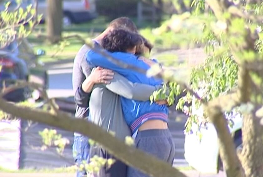 People console each other at Wheaton College after a tragic accident at a track meet on Saturday. | Screenshot from NVP video