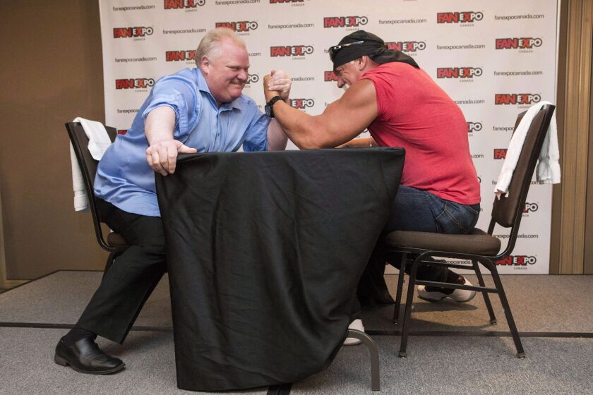 In this Aug. 23, 2013, file photo, Toronto Mayor Rob Ford, left, takes on Hulk Hogan in an arm-wrestling match to promote Fan Expo in Toronto. Chris Young / The Canadian Press via AP