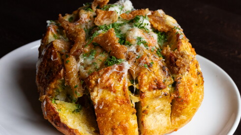 The stuffed cheese bread, made with Midwestern cheese and crispy chicharrón-style duck cracklings, is one of the shareable items at Gunny's Pub in Lincoln Park.