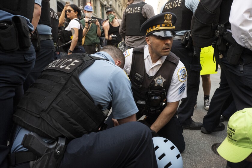 Police detain a demonstrator. It wasn't clear late Tuesday how many people had been arrested.