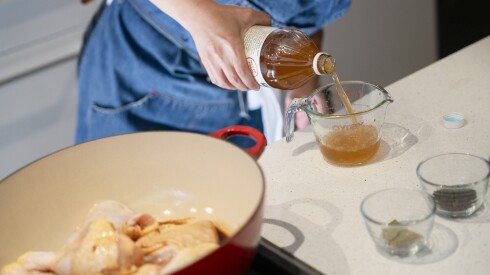 Chicago Sun-Times Assistant Features Editor Dorothy Hernandez pours apple cider vinegar into a measuring cup as she makes author Mia P. Manansala’s version of “adobo,” which is published in one of Manansala’s books, at the Miele Experience Center Chicago at THE MART in River North, Wednesday, Nov. 12, 2025. | Pat Nabong/Sun-Times