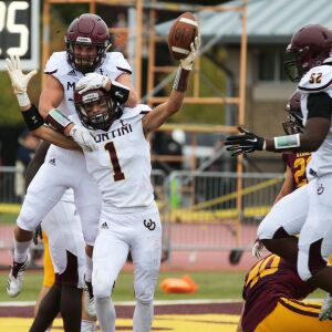 Montini’s Scott West (1), Zach Olson, and Jeremiah Banks-Wall (52) celebrate. Allen Cunningham/For the Sun-Times.