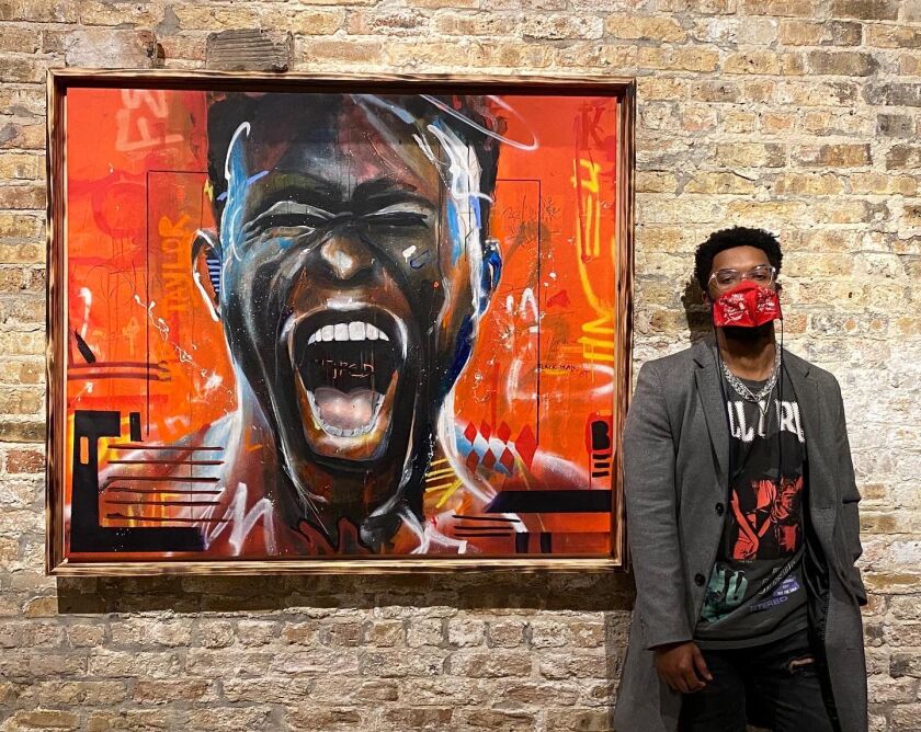 Dwight White II in front of one his paintings.