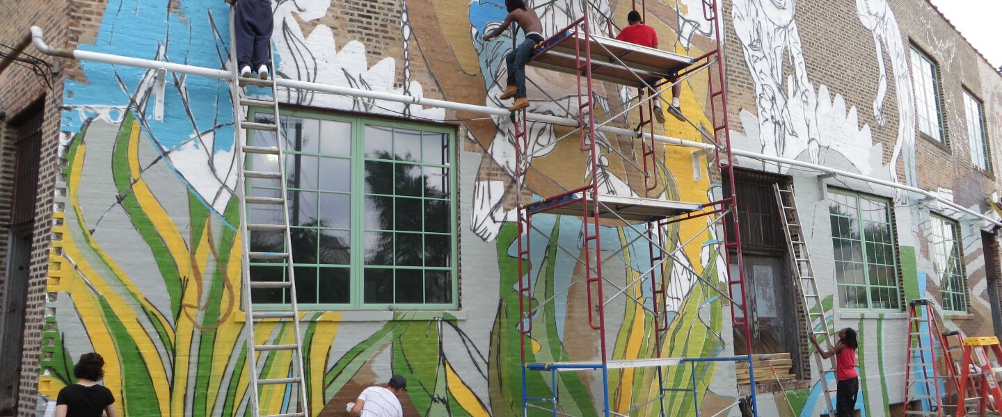 Volunteers worked with artist Joe Miller to produce the mural at The Plant.