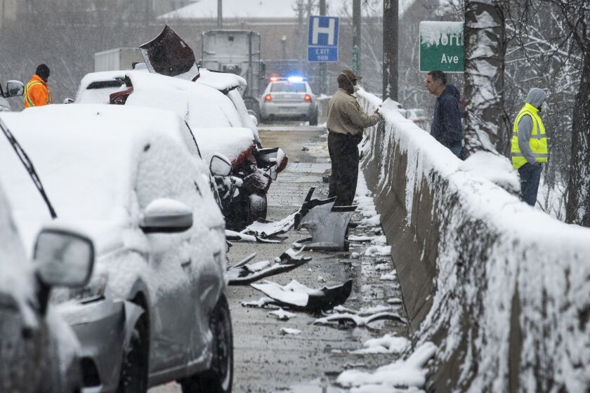 An Illinois State Police trooper investigates the scene of a massive pileup crash involving nearly 60 vehicles, sending more than a dozen people to hospitals, in the inbound lanes of the Kennedy Expressway near North Avenue, Wednesday morning, April 15, 2020.
