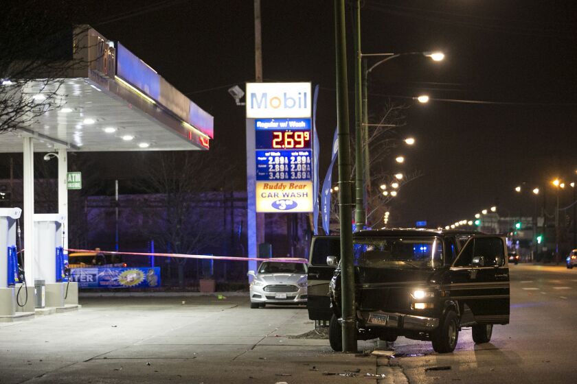 Chicago Police investigate in the 5900 block of South Western, where an 18-year-old woman and 24-year-old man were both shot early Saturday, Dec. 23, 2017. | Ashlee Rezin/Sun-Times
