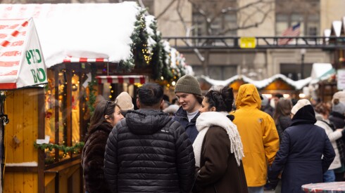 Shoppers chat at Daley Plaza’s Christkindlmarket in the Loop after the snowiest November day ever recorded in Chicago, Sunday, Nov. 30, 2025.