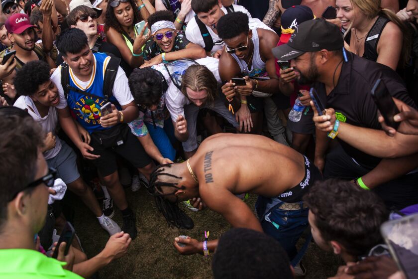 Chicago native Supa Bwe jumps into the crowd as he performs Friday afternoon on day one of the Summer Smash Festival in Douglass Park.