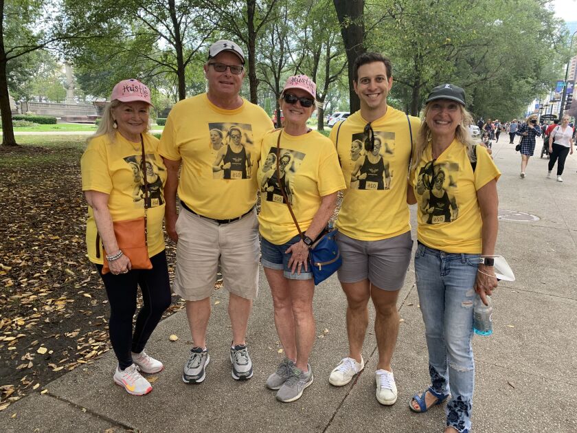 Don Lamb (second from left) and Dan Short (second from right) cheer on Lamb’s daughter and Short’s wife, Erin Short, during the 43rd Chicago Marathon on Oct. 10, 2021.