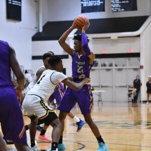 Waukegan’s Bryant Brown (25) holds the ball in a December game against Marian Catholic. Worsom Robinson/For the Sun-Times.