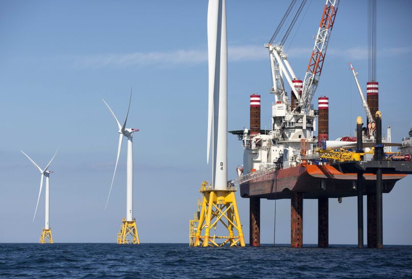 A lift boat (right) that serves as a work platform is used to assemble a wind turbine off Block Island, R.I.