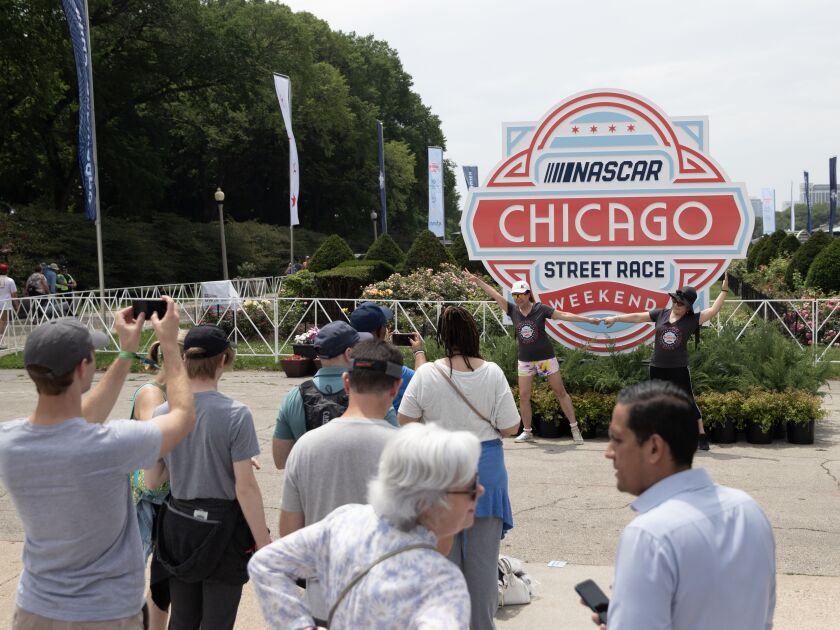 People line up to take pictures at the NASCAR Chicago Street Race festival on Saturday, July 1, 2023 in Chicago.