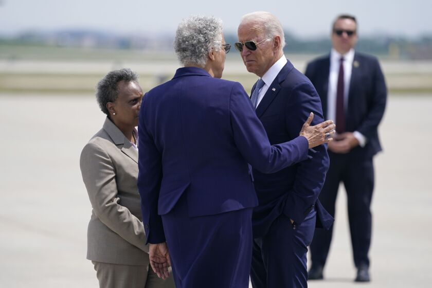 President Joe Biden is greeted by Cook County Board President Toni Preckwinkle, center, and Chicago Mayor Lori Lightfoot, left, as he arrives at O’Hare International Airport, Wednesday.