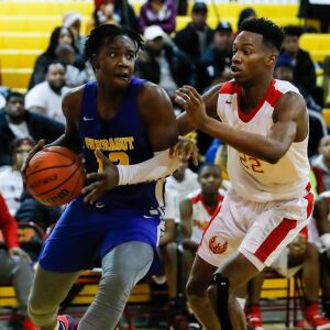 Farragut’s Mikqwon Jones (12) drives past North Lawndale’s Larry Johnson (22).