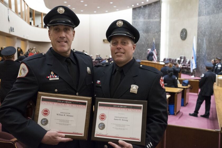 Chicago Firefighters William Monaco and James Sewnig and at City Hall after receiving the Special Honorable Mention for rescuing Nina Steen from a fire. | Rick Majewski/For the Sun-Times