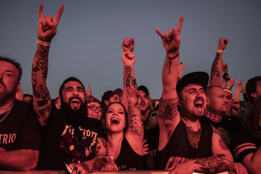 Fans cheer as Alkaline Trio performs at Riot Fest on Thursday night.