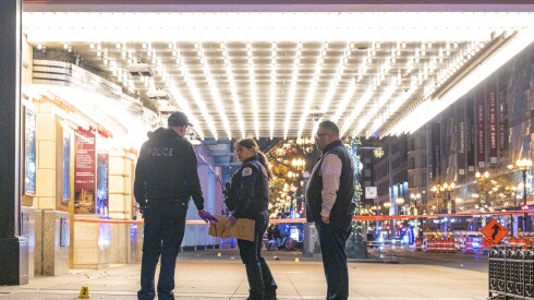 Chicago police investigate the scene where multiple people were shot outside the Chicago Theatre in the Loop, Friday, Nov. 21, 2025.