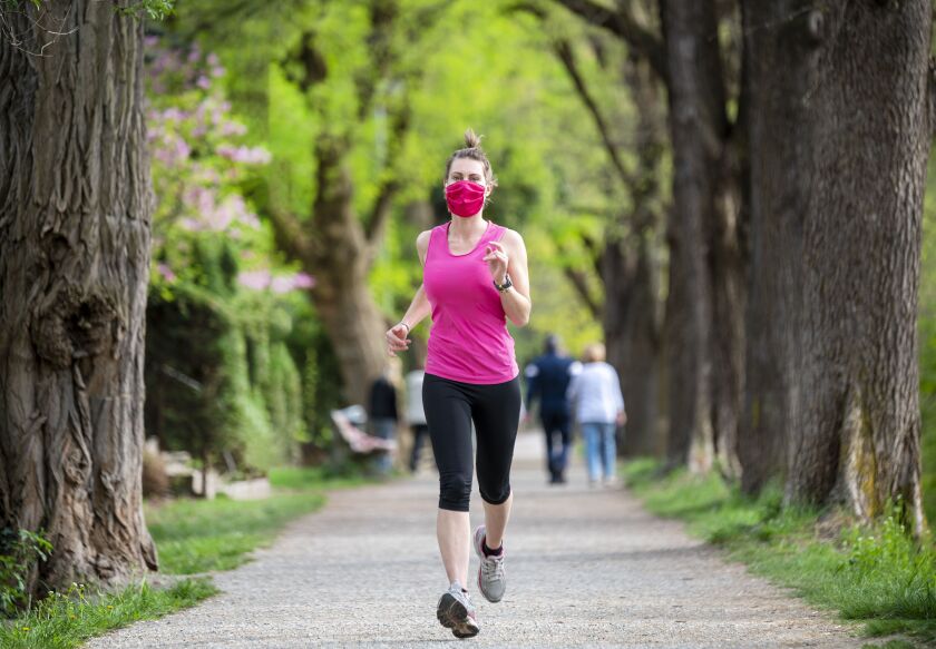 Wearing a mask while running “is not going to be practical,” one CDC official says, predicting exercisers will remove them to breathe out of their noses.