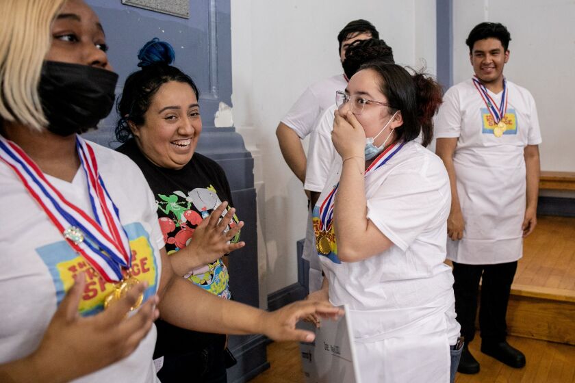 Cynthia Sandoval, a student at North-Grand High School, learns all students in the Food Truck Wars competition would receive $100 to purchase their own chef’s jackets.