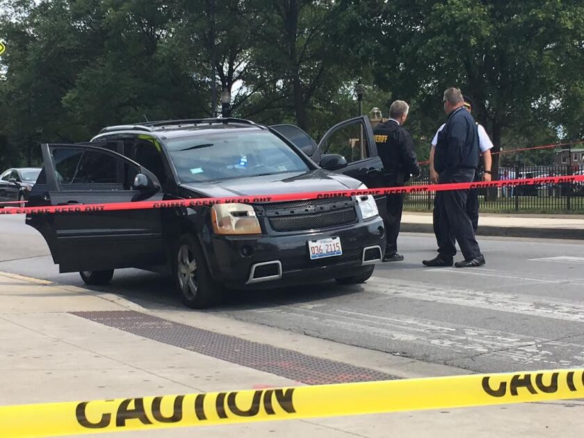 A black SUV is checked by police outside the Cook County Courthouse at 26th and California. The driver stopped there and dropped off a man who had been shot. | Andy Grimm/Sun-Times