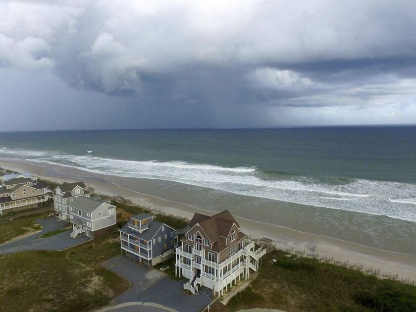 A storm front passes homes in North Topsail Beach, N.C., prior to Hurricane Florence moving toward the east coast on Wednesday, Sept. 12, 2018. | AP Photo