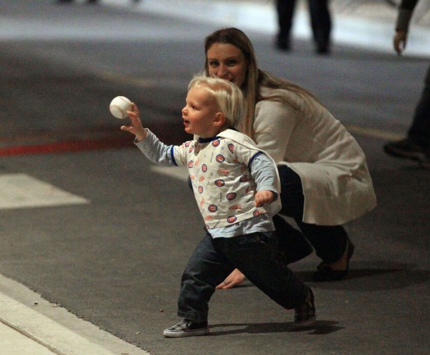 Blake Dakota, of Chicago, tosses the ball around outside Wrigley Field on Wednesday. Maybe he could pitch for the Cubs in 20 years? | Kevin Tanaka/For the Sun-Times