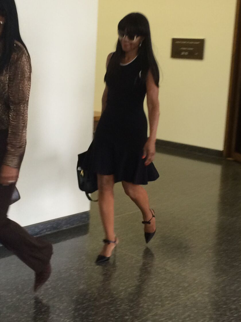 <small><strong>Regina Rice, the caretaker of the late Cubs legend Ernie Banks, leaves court after a brief hearing at the Daley Center. | Rummana Hussain/Sun-Times</strong></small>