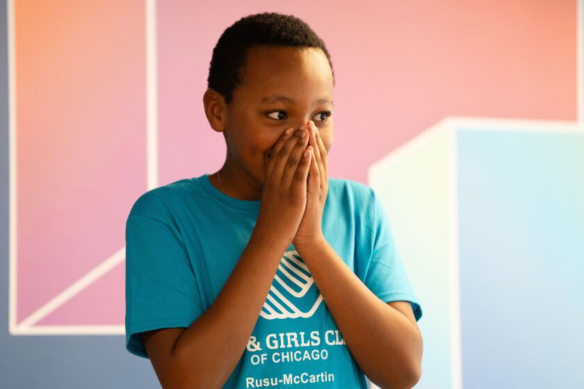 Chris Harris, 13, who performed a poem with his twin, reacts as visitors clap for them after the ribbon cutting ceremony at the new Boys and Girls Clubs of Chicago’s Rusu-McCartin Club on the West Side, Friday, Aug. 18, 2023.