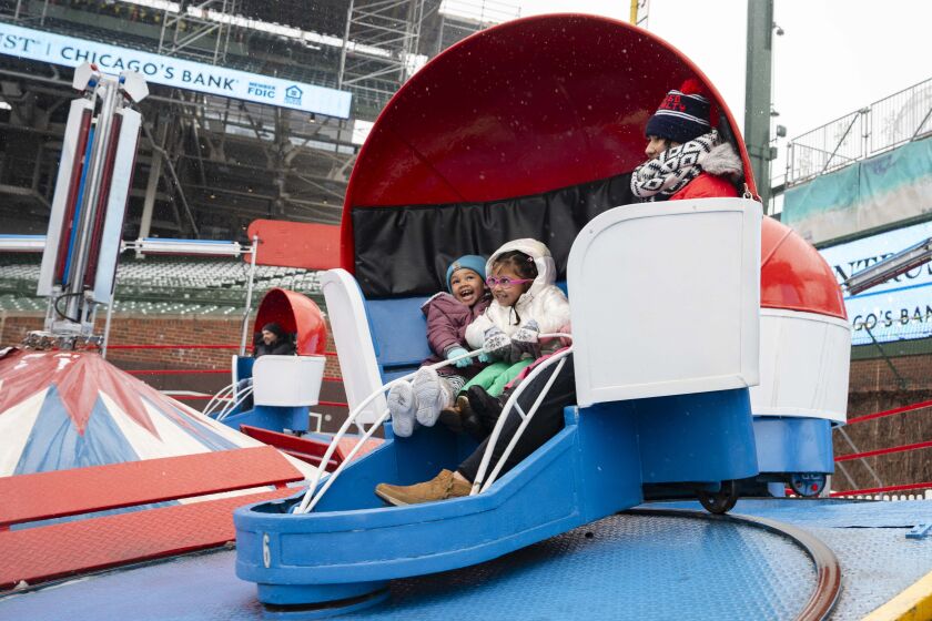From left: Mara Felton, 5, Victoria Matallana, 5, and Natalia Roncancio ride the Tilt-A-Whirl for Matallana’s birthday celebration during Wintrust Winterland at Wrigley Field in the Wrigleyville neighborhood, Saturday, Jan. 6.