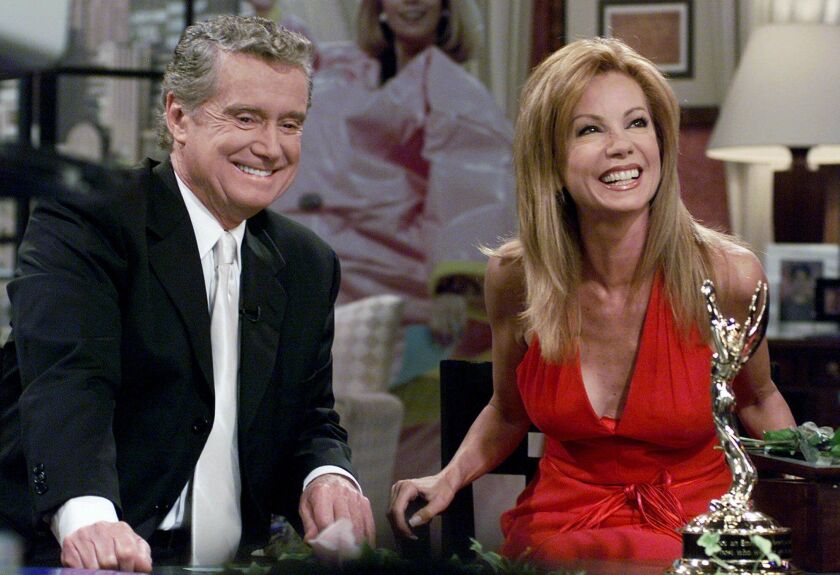 In this July 28, 2000 file photo, Kathie Lee Gifford and co-host Regis Philbin reminisce during her last appearance on the show, in New York.