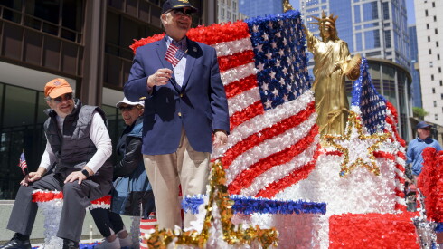 A float carries a replica of the Statue of Liberty during a parade commemorating Memorial Day on North Dearborn Street in the Loop on Saturday.