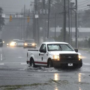 A vehicle with the Wilmington Fire Department drives through a flooded street from Florence, now a tropical storm in Wilmington, N.C., Saturday, Sept. 15, 2018. (Matt Born/The Star-News via AP)