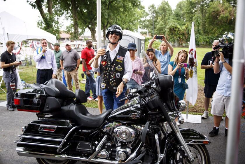 Gov. Bruce Rauner arrives on his motorcycle for the Republican Day rally at the Illinois State Fair in Springfield, Ill. Wednesday, Aug. 16, 2017. (Rich Saal/The State Journal-Register via AP)