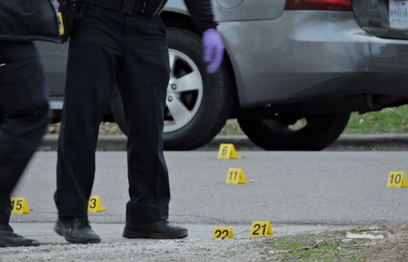 Evidence markers are strewn on the street in the 3500 block of West Van Buren on Sunday, April 2, 2017. | Brian Jackson/For the Sun-Times