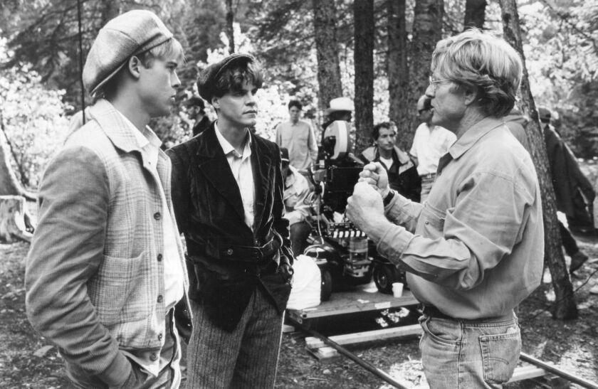 Director Robert Redford discusses a scene with Brad Pitt and Craig Sheffer in the film “A River Runs Through It.”