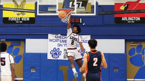 St. Viator's Dawson Charles (2) throws down an early dunk during the Lions' victory over Buffalo Grove.