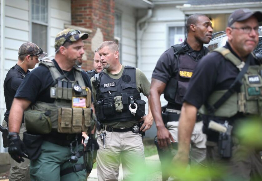Police search in and around a building near the defunct cement plant where Lt. Joe Gliniewicz was killed as they continue to follow leads in his murder on Sept. 2, 2015 in Fox Lake, Illinois. | Scott Olson/Getty Images