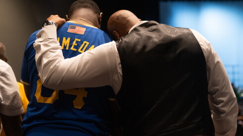 A mourner wears a jersey from Simeon Career Academy at basketball coach Tim Bankston’s memorial service.