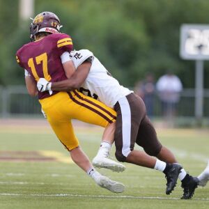 Mount Carmel’s Koron Walker, white jersey, sacks Loyola’s Matthew Schiltz. Allen Cunningham/For the Sun-Times.