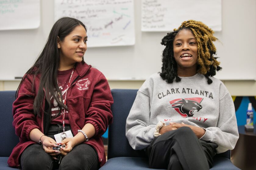 Esdaini Lopez, 17, and Kierra Richie, 17, discuss the changes since an officer was removed from Gage Park High School.