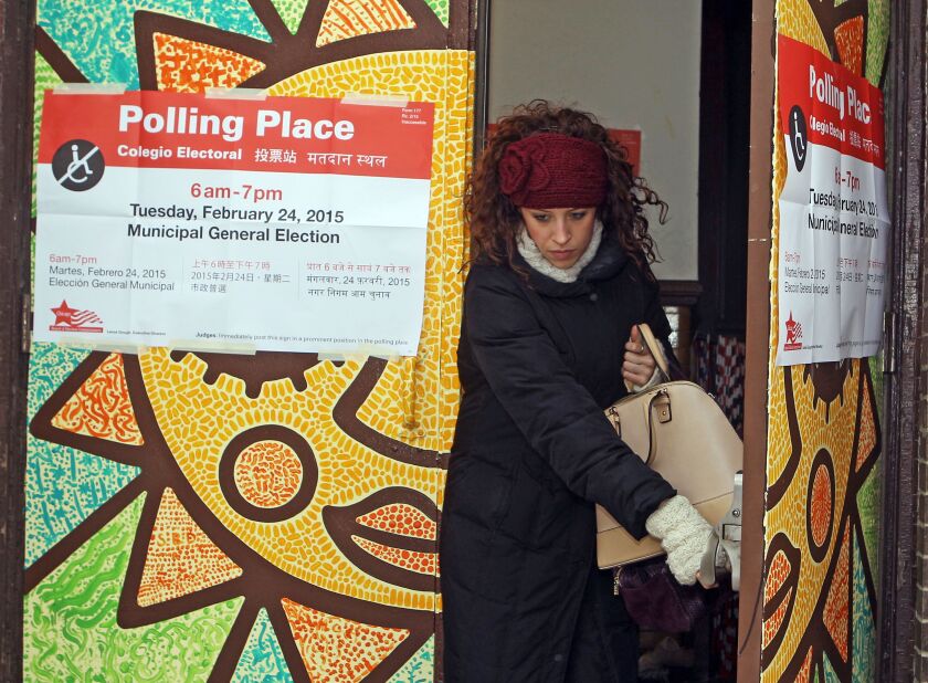 Kristi Forsch is bundled up for the cold weather as she leaves Agassiz Elementary School after voting Tuesday, Feb.24, 2015. | Kevin Tanaka/For Sun-Times Media