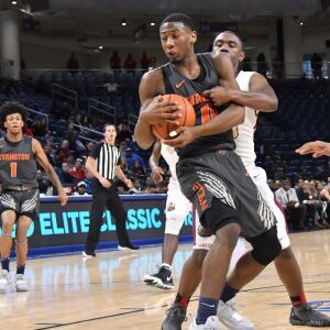 Uplift’s DeAndre Vortes (15) wraps up Evanston’s Jaylin Gibson (0). Worsom Robinson/For the Sun-Times.