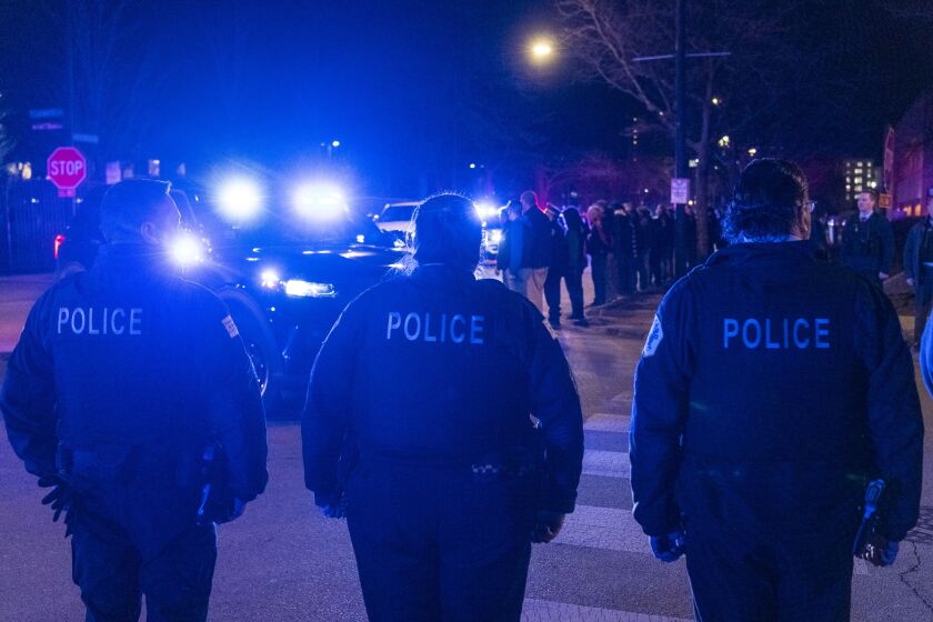 An ambulance carrying the body of a Chicago police officer who died of an apparent suicide arrives at the Cook County medical examiner’s office on the Near West Side Friday night, March 5, 2021.