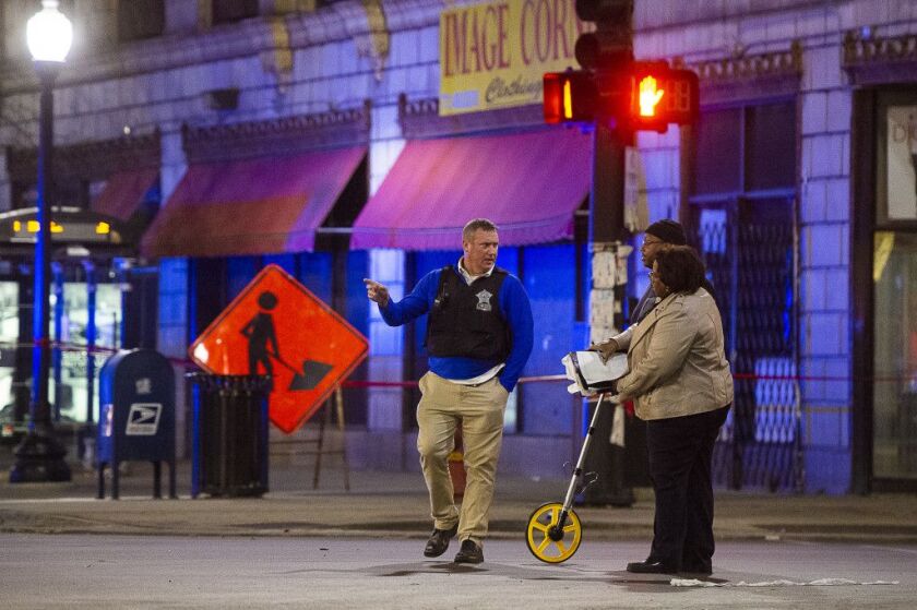 Police investigate the scene of a fatal hit-and-run, Tuesday morning in the 7900 block of South Cottage Grove. The victim was stuck on 79th and Cottage Grove and his body was dragged to 79th and Dobson. | Tyler LaRiviere/Sun-Times