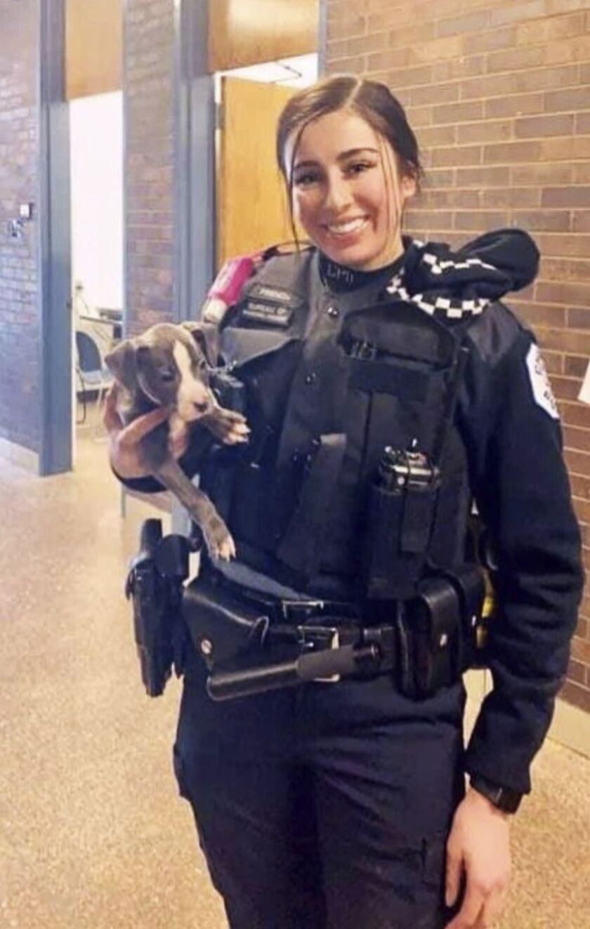Officer Ella French with a dog she rescued.